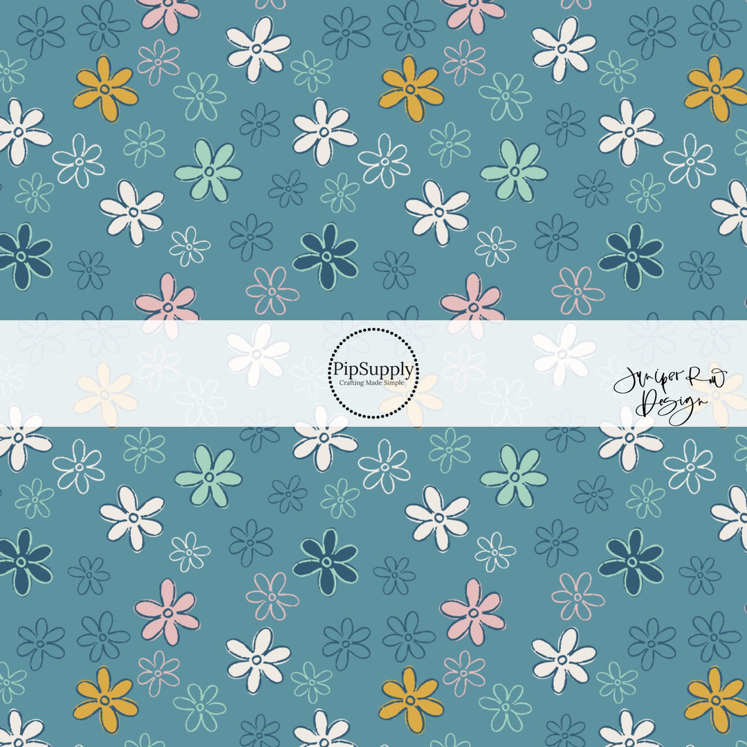 Blue fabric by the yard with pink, navy blue, white, and aqua doodled daisies.