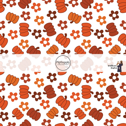 White fabric by the yard with range and rust colored pumpkins and flowers.