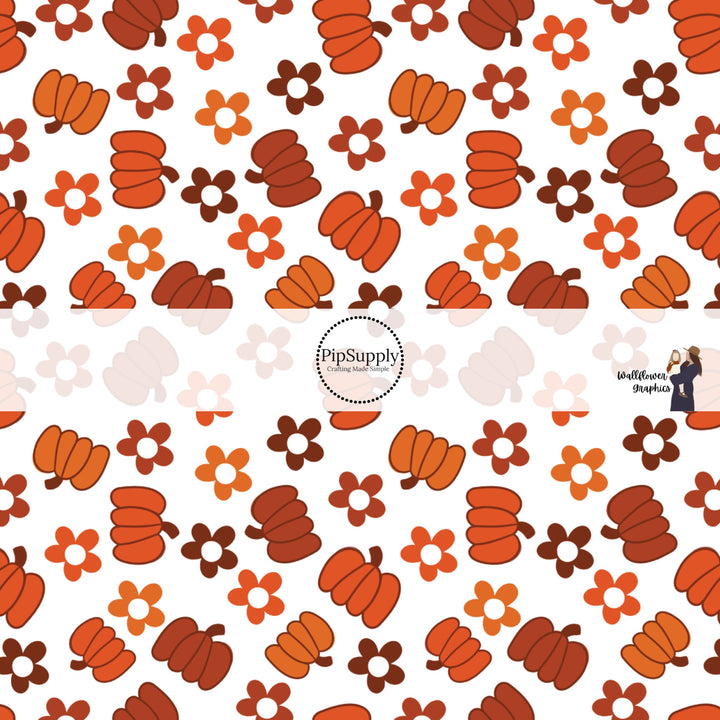 White fabric by the yard with range and rust colored pumpkins and flowers.