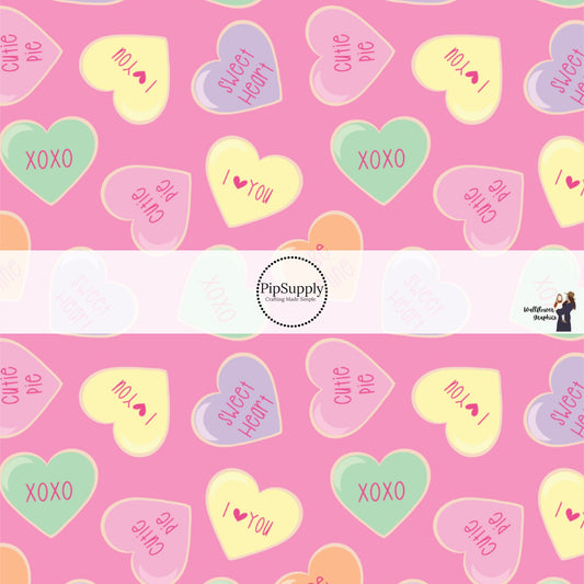 These Valentine's pattern themed fabric by the yard features pastel colored conversation hearts on pink. This fun Valentine's Day fabric can be used for all your sewing and crafting needs! 