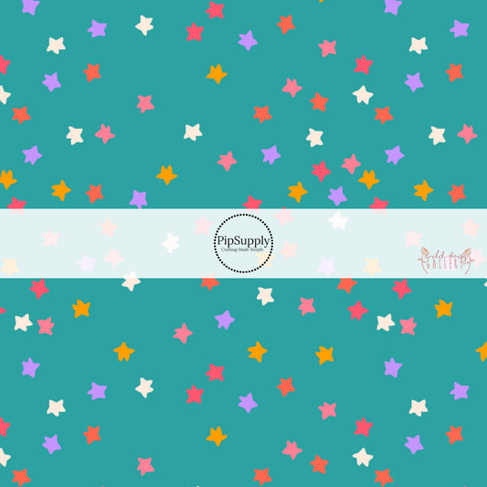 Teal fabric by the yard with white, pink, yellow, pink, and purple scattered stars.