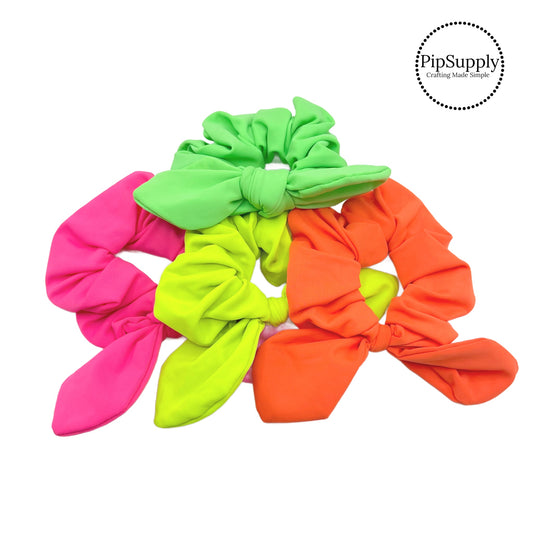 bright green yellow pink and orange neon swim scrunchies with bow