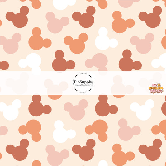 Cream fabric by the yard with white, pink, and orange mouse head silhouette fabric by the yard.