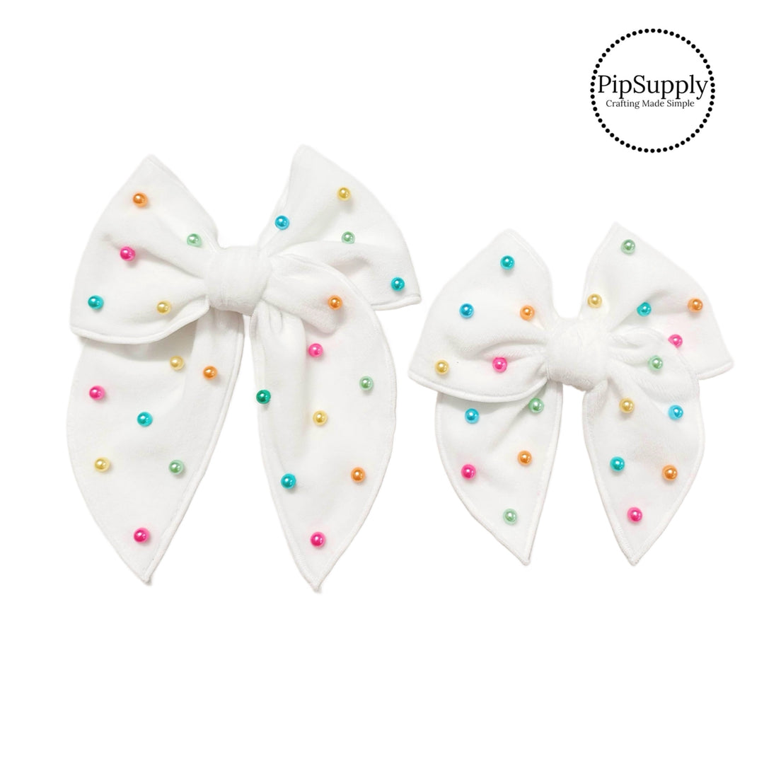 pastel pearls sewn on off white velvet tied hair bows