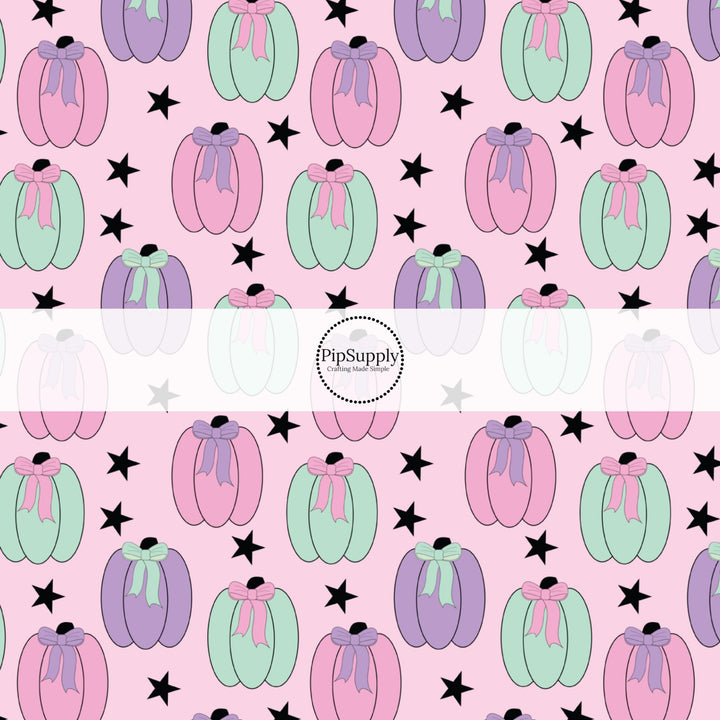 These Halloween themed pattern fabric by the yard features the following design elements: colorful pumpkins on light pink. This fun spooky themed fabric can be used for all your sewing and crafting needs!