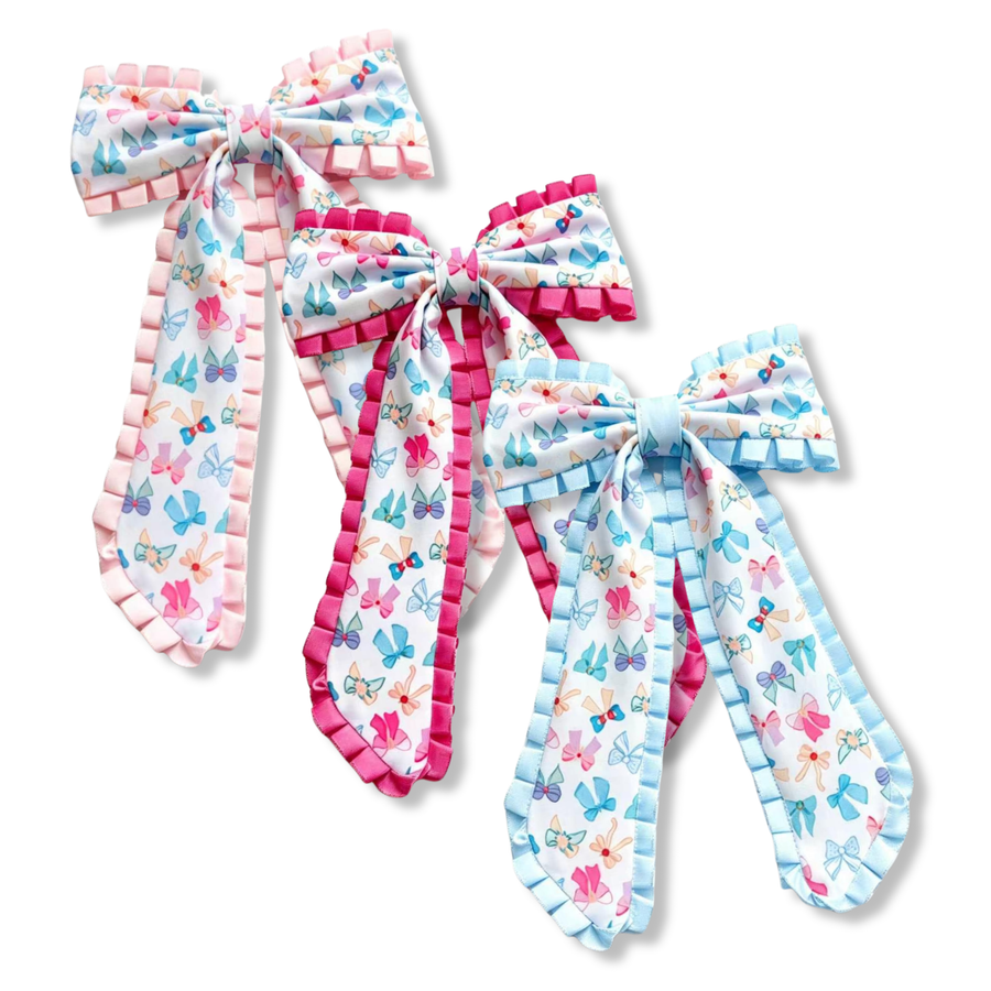 These whimsical bows feature a white ribbon printed with colorful bows and floral accents in soft shades of pink, blue, purple, and peach. Each bow is finished with coordinating ruffle trim in blush pink, bright pink, or light blue, adding texture and charm. Perfect for adding a sweet, playful touch to any outfit.
you choose ruffle color
Large 5.5" X 9.5"