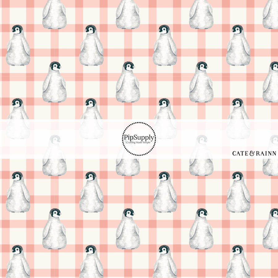 White fabric by the yard with a peach plaid and penguin print.