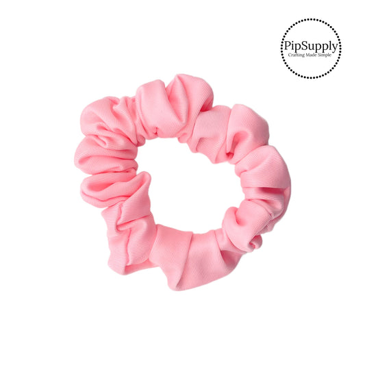 These peachy pink swim scrunchies have a two layer swimsuit fabric strip with edges that are securely folded and sewn providing a professional and high quality seam. Fabric is thick high quality not coarse or stiff with elastic band sewn inside for stretch-ability. Pattern visible on all sides. 