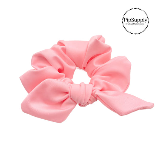 These peachy pink swim scrunchies have a two layer swimsuit fabric strip with edges that are securely folded and sewn providing a professional and high quality seam. Fabric is thick high quality not coarse or stiff with elastic band sewn inside for stretch-ability. Pattern visible on all sides. Bow comes pre-tied on scrunchie however is removable to be available as separate bow.