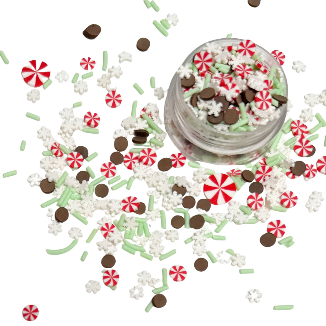 This Peppermint Snowflake clay slice mix is versatile for many craft projects. Made with red and white peppermint, white and mint sprinkles and brown dots. You can use it to add sparkle and decoration to resin projects, filling for shaker bows, slime making, party decor, scrapbooking, card making and nail art.

This loose clay mix is sold in a resealable 1OZ Bag

- Material: Polymer Clay and Glitter