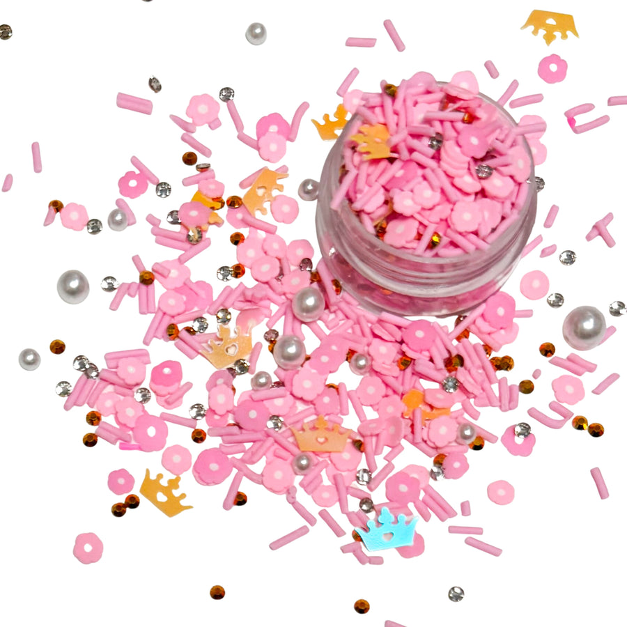 This princess inspired clay slice mix is versatile for many craft projects. This princess mix has gold crowns and pearls with pink clay pieces and rhinestones. You can use it to add sparkle and decoration to resin projects, filling for shaker bows, slime making, party decor, scrapbooking, card making and nail art.

This loose clay mix is sold in a resealable 1OZ Bag

- Material: Polymer Clay and Glitter