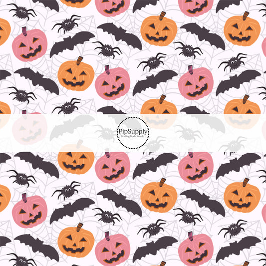 Bone white fabric by the yard with pumpkins, bats, and spiderwebs.