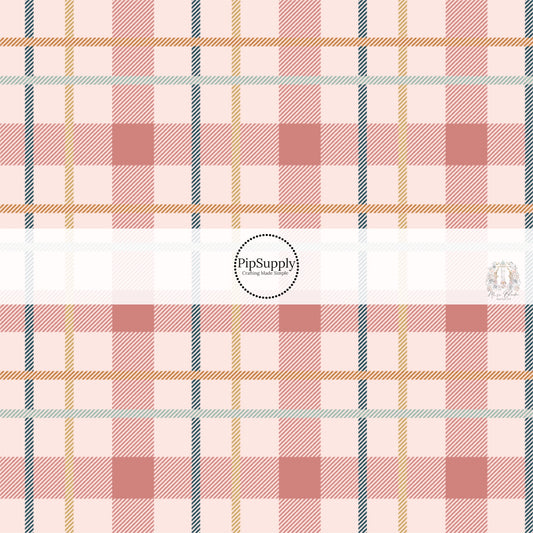 Blue, yellow, and pink plaid print on light pink fabric by the yard.