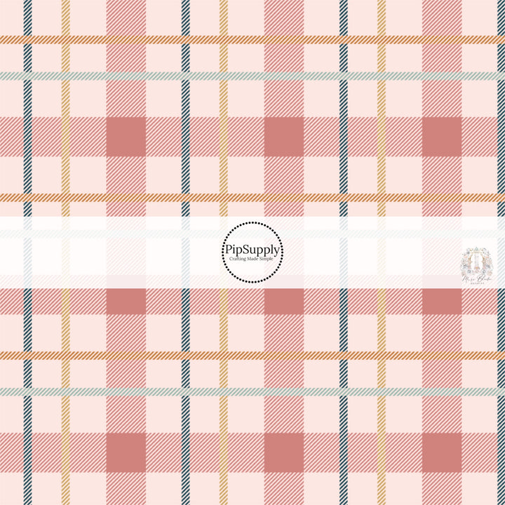 Blue, yellow, and pink plaid print on light pink fabric by the yard.