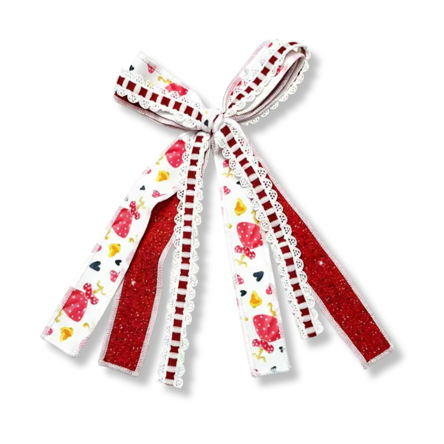 This layered streamer bow features red glitter ribbons paired with character-inspired printed ribbons featuring red polka-dot bows and hearts. White scalloped lace trim and red-and-white ladder ribbon accents add texture and charm, while the flowing tails create a playful, eye-catching finish.
Bow Sizing 4" x 8"