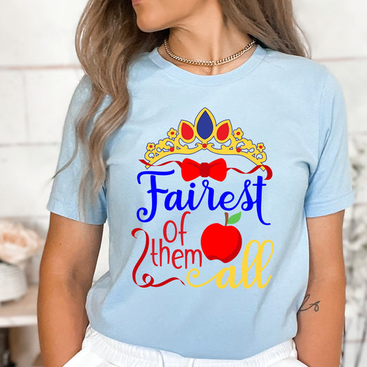Red and blue princess iron on heat transfer that says "Fairest of Them All" and has an apple and a tiara.