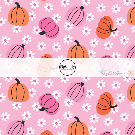 These Halloween themed pink fabric by the yard features orange and pink pumpkins surrounded by tiny white daisies on pink. This fun spooky themed fabric can be used for all your sewing and crafting needs! 