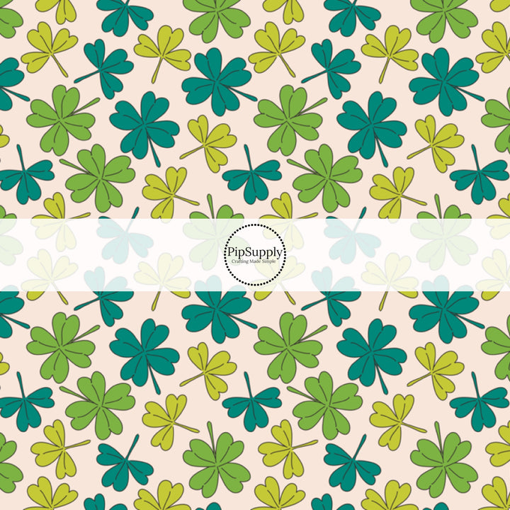 Scattered Multi-Green Clovers on Cream Fabric by the Yard.