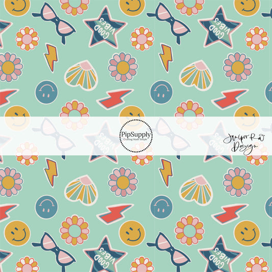 Smiley faces, glasses, lightning bolts, and flowers school themed stickers on aqua blue fabric by the yard.