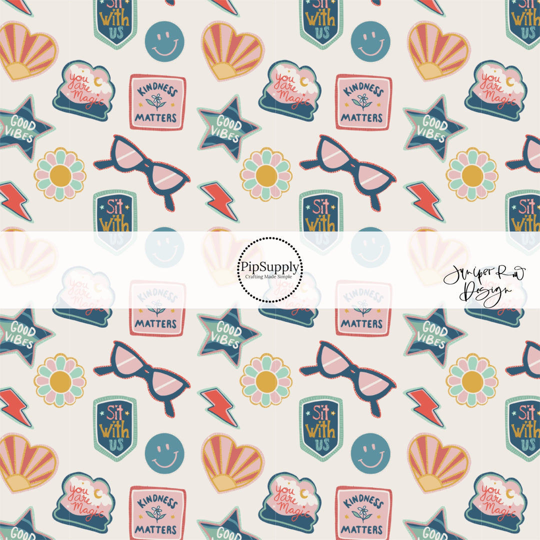 Smiley faces, glasses, lightning bolts, and flowers school themed stickers on cream fabric by the yard.