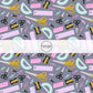 Drak grey fabric by the yard with school supplies such as scissors, erasers, and rulers.