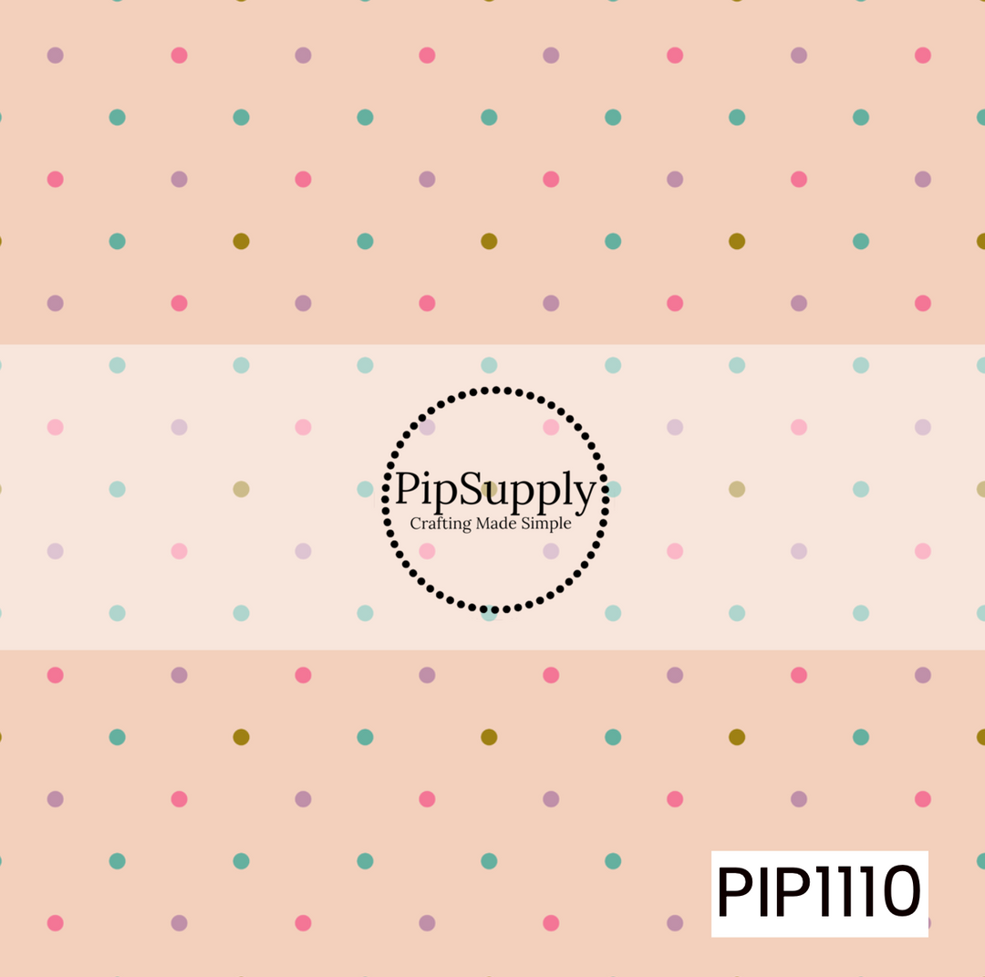 A soft peach background with scattered pastel polka dots in teal, pink, lavender, and mustard creates a sweet, playful coordinate.