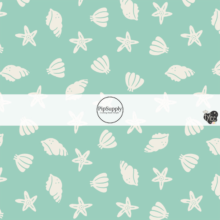 This beach fabric by the yard features seashells on light green. This fun themed fabric can be used for all your sewing and crafting needs!