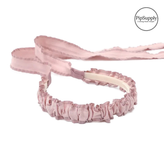 These summer shimmer woven ruffled tie back headbands are a stylish hair accessory and have the on and off ease of a headband. These headbands are a perfect simple and fashionable answer to keeping your hair back! The headbands feature long ribbons at the ends of the headband to tie into a bow.