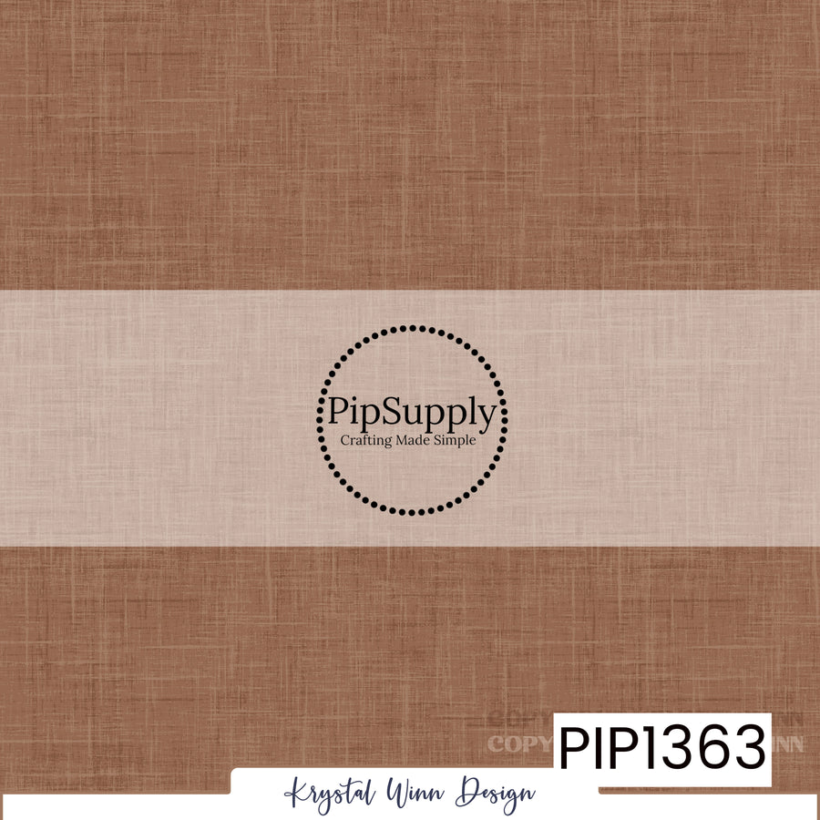 A warm, muted medium brown solid background with soft caramel and earthy undertones, featuring a delicate woven linen texture with fine crosshatched fibers and subtle tonal variations, creating a cozy, rustic, fabric-inspired appearance.