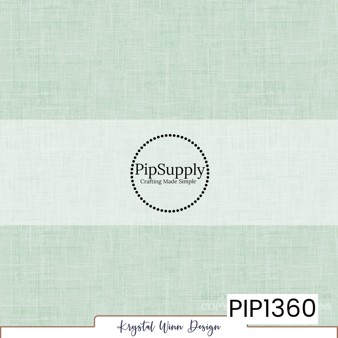 A soft, pale mint green solid background featuring a delicate woven linen texture with fine crosshatched fibers and subtle tonal variations, creating a light, airy, fabric-inspired appearance.