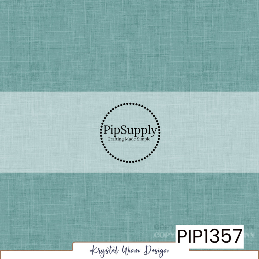 A soft, muted teal blue solid background featuring a delicate woven linen texture with fine crosshatched fibers and subtle tonal variations, creating a slightly weathered, fabric-inspired appearance.