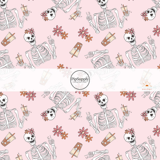 Light pink fabric by the yard with florals and skeletons drinking iced coffee.