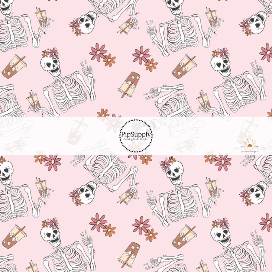 Light pink fabric by the yard with florals and skeletons drinking iced coffee.