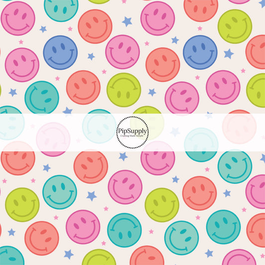 Cream fabric by the yard with blue and pink stars and multi-colored smiley faces.