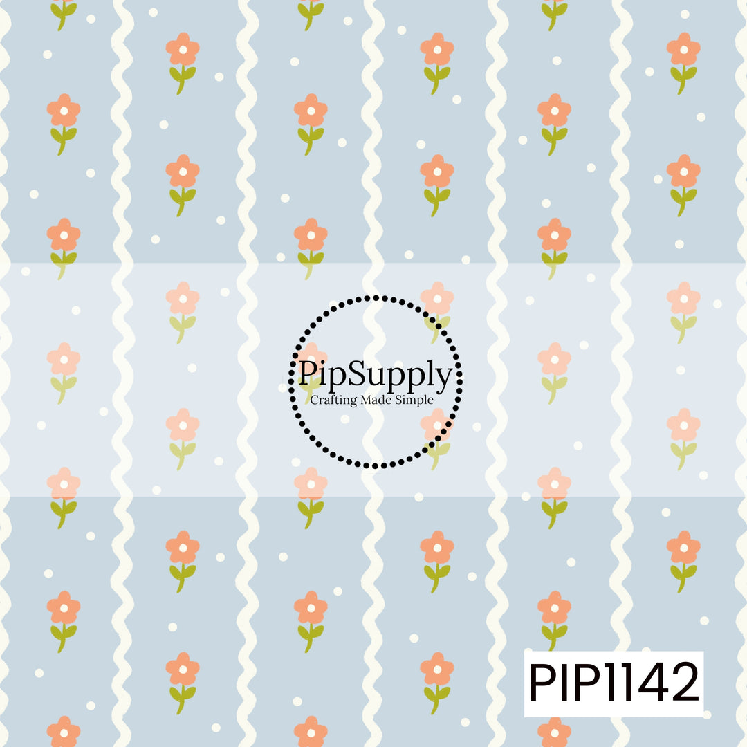 A playful pale-blue pattern featuring vertical ivory wavy stripes, scattered coral flowers with green stems, and tiny white dots.

