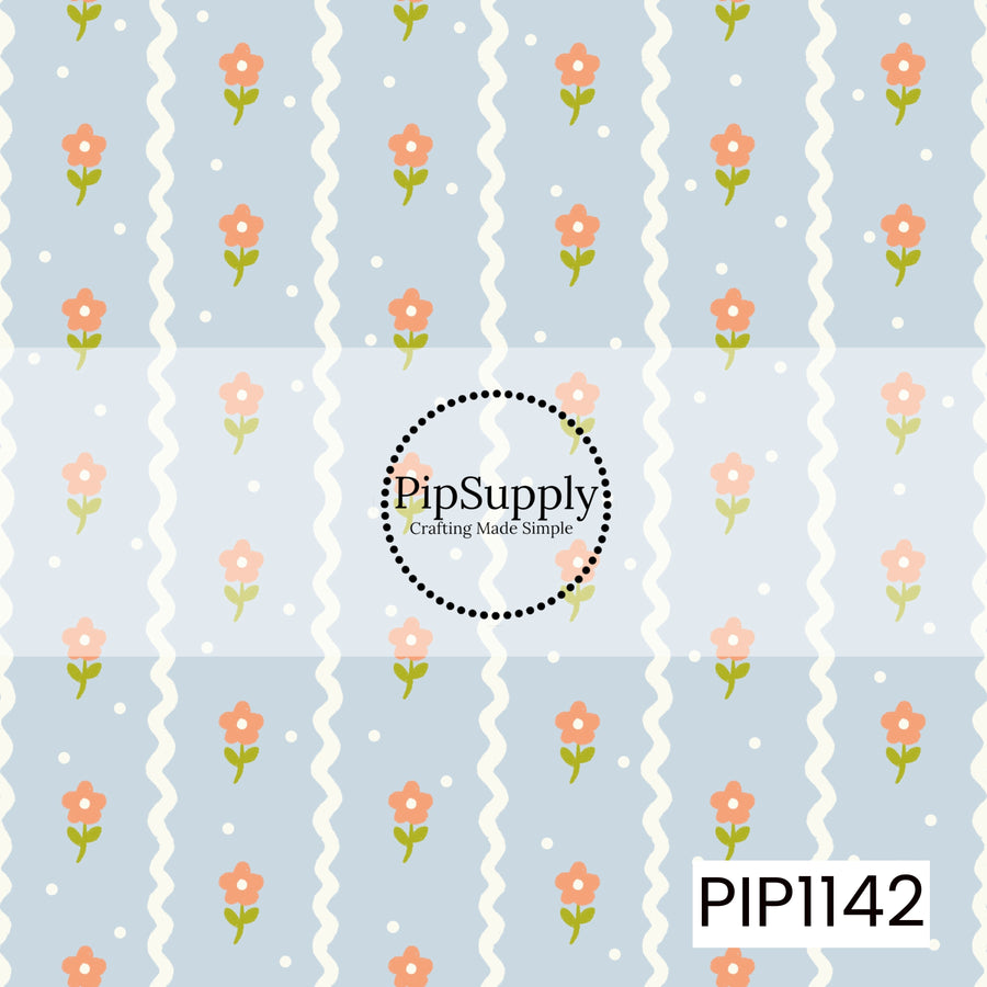 A playful pale-blue pattern featuring vertical ivory wavy stripes, scattered coral flowers with green stems, and tiny white dots.
