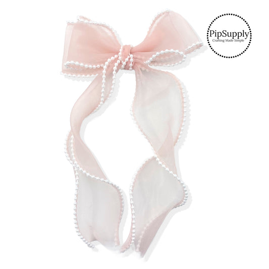 These stacked pearl trimmed organza long ribbon hair bows are ready to package and resell to your customers no sewing or measuring necessary! These come pre-tied with an attached alligator clip. The delicate bow is perfect for all hair styles for kids and adults. The bow has a white pearl trim.