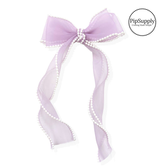 These stacked pearl trimmed organza long ribbon hair bows are ready to package and resell to your customers no sewing or measuring necessary! These come pre-tied with an attached alligator clip. The delicate bow is perfect for all hair styles for kids and adults. The bow has a white pearl trim.