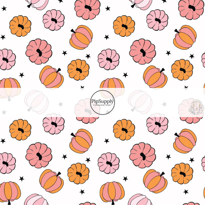 White fabric by the yard with pink and orange colored pumpkins and black stars.