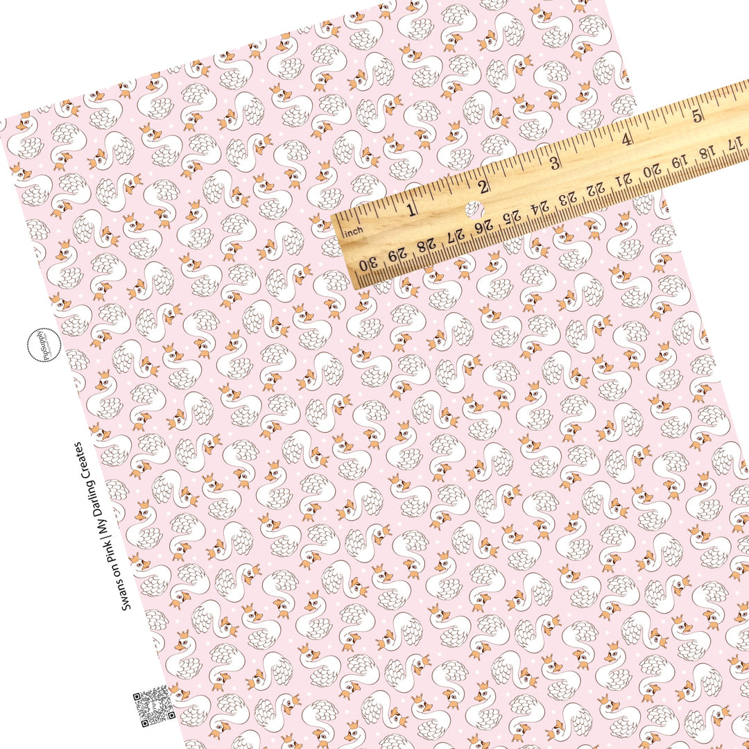 These Valentine's pattern themed faux leather sheets contain the following design elements: white swan birds with crowns surrounded by tiny white stars on light pink. Our CPSIA compliant faux leather sheets or rolls can be used for all types of crafting projects.