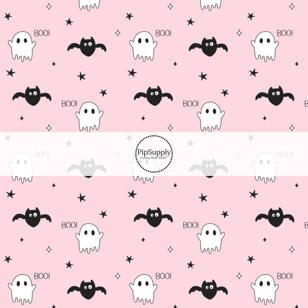 Ghosts, Bats, stars, and the word "BOO!" on light pink fabric by the yard.