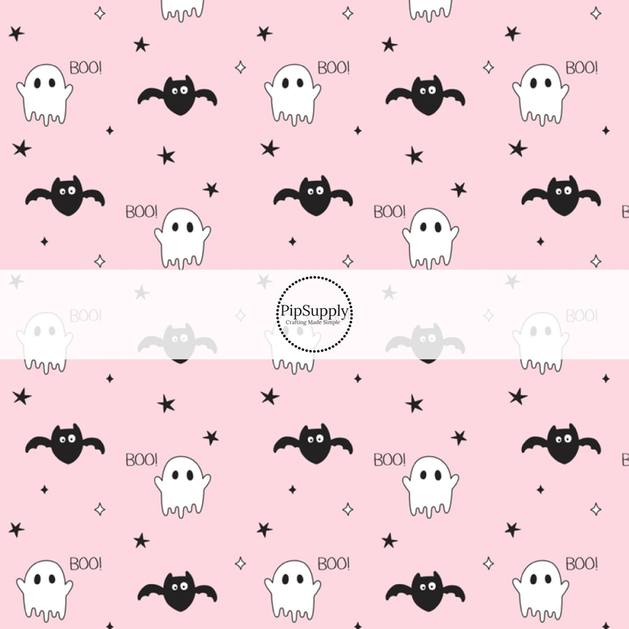 Ghosts, Bats, stars, and the word "BOO!" on light pink fabric by the yard.