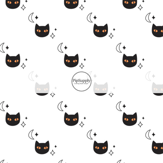 Black cats with orange eyes, moons, and stars, on white fabric by the yard.