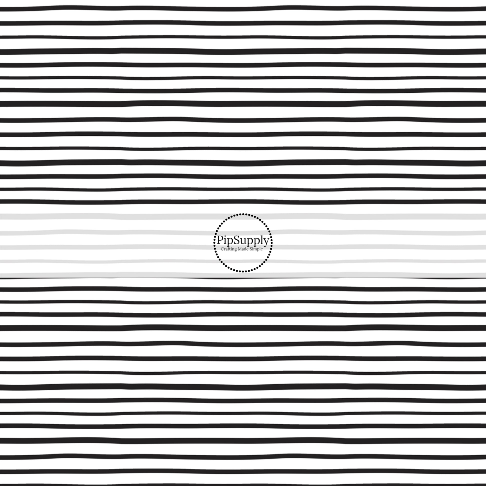 Thin black stripes on white fabric by the yard.