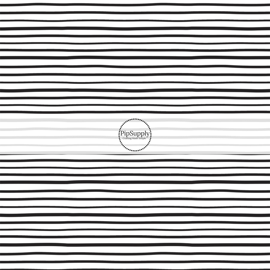 Thin black stripes on white fabric by the yard.