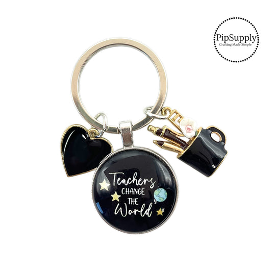 Black heart charm, school supplies charm, and gratitude charm on a round silver keychain ring. The teacher appreciation charm has the following phrase: "Teachers Change The World." These silver key chains are perfect to add to your everyday key ring or give as a gift to a teacher!! These are ready to use or sell to others.