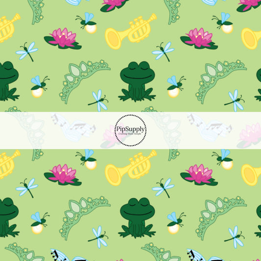 Green frog princess fabric by the yard with waterl-lilies, fireflies, dragonflies, trumpets, and tiaras.