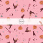 Pink fabric by the yard with stars, moons, pumpkins, witch hats, and broom sticks.