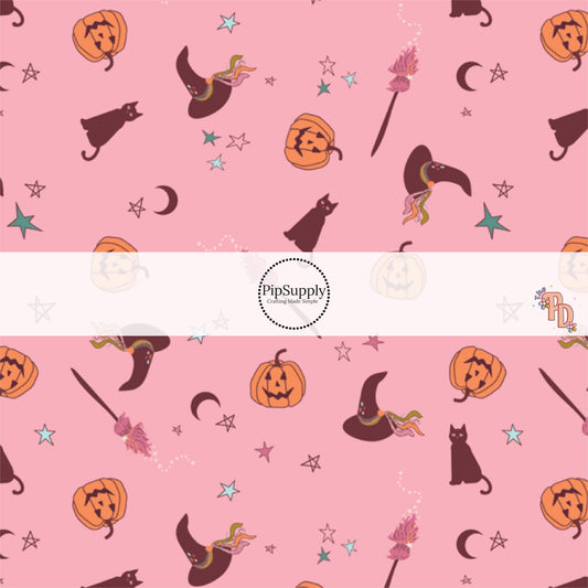 Pink fabric by the yard with stars, moons, pumpkins, witch hats, and broom sticks.