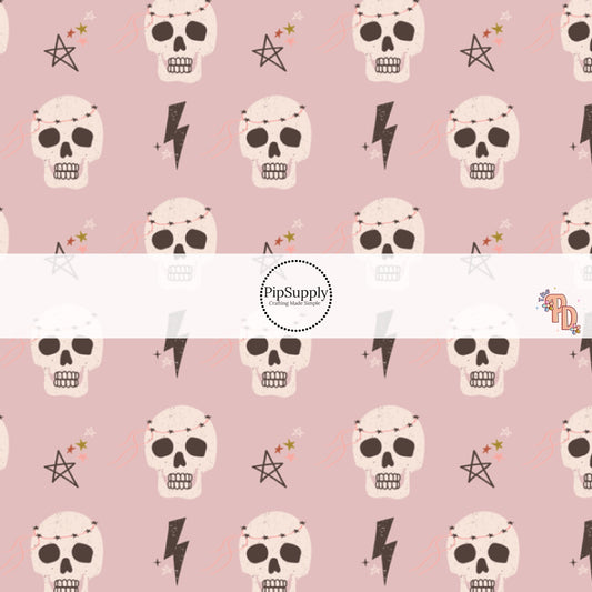 Light purple fabric by the yard with skulls, lightning bolts, and stars.